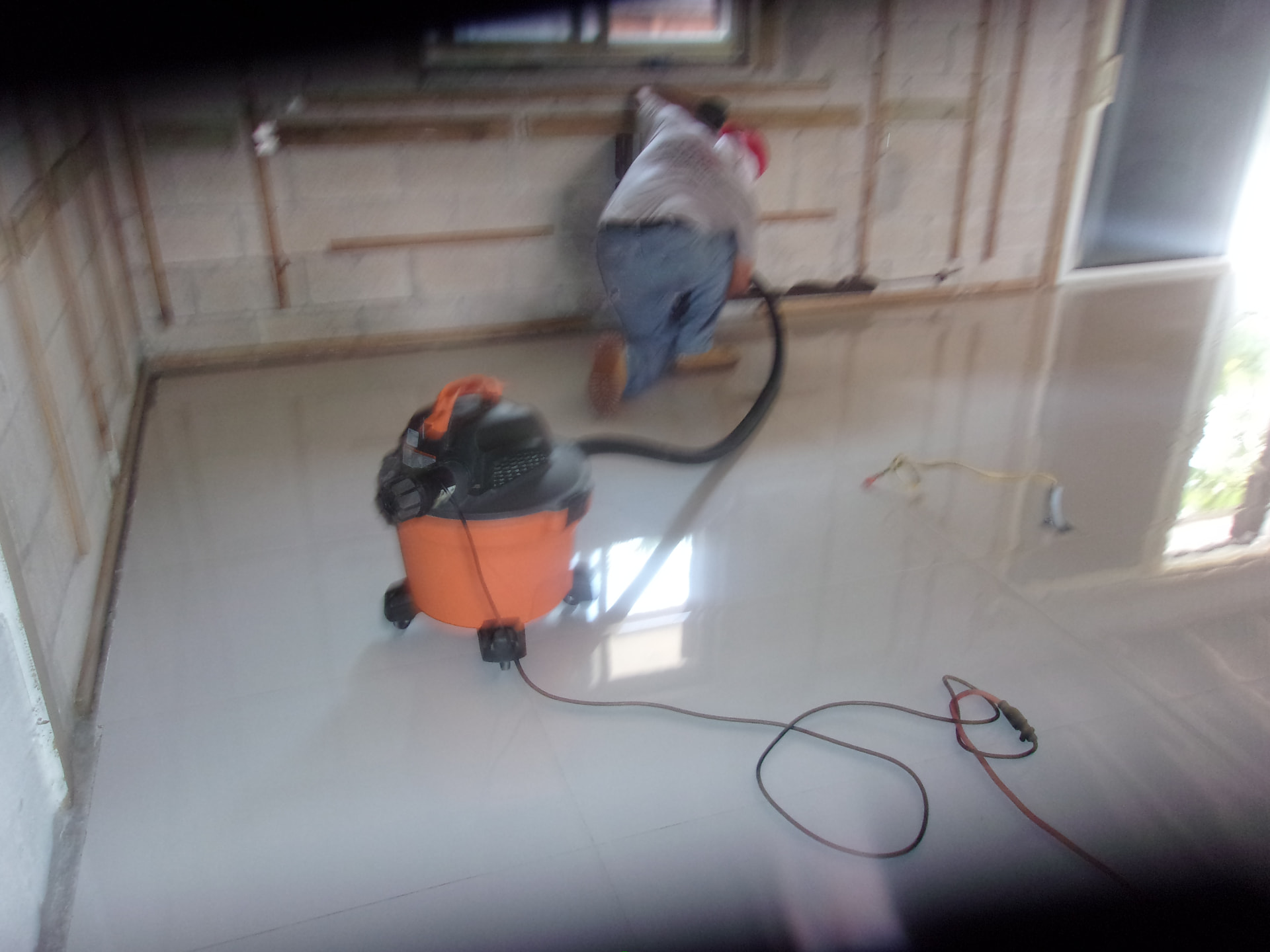 Technician using professional cleaning equipment in a stripped interior