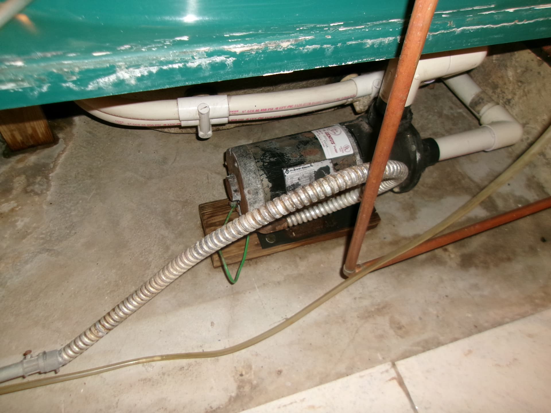 Exposed plumbing and pump during burst pipe cleanup