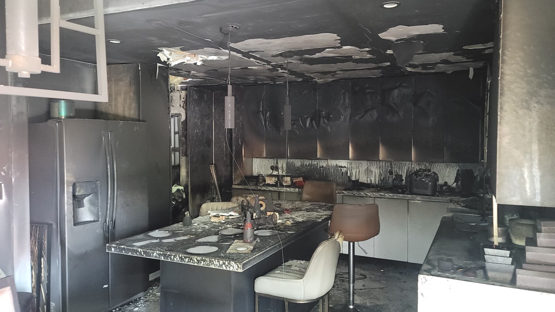 Fire and smoke damage throughout a residential kitchen
