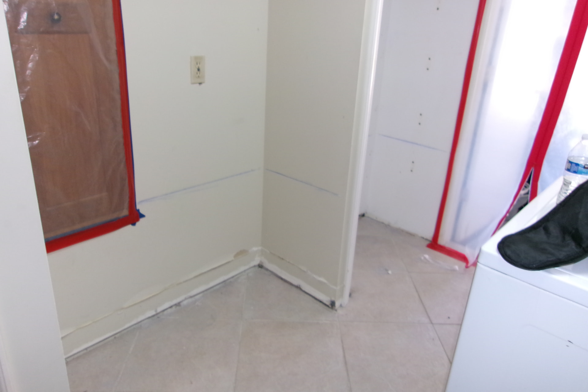 Cleaned corner with containment tape after mold remediation verification