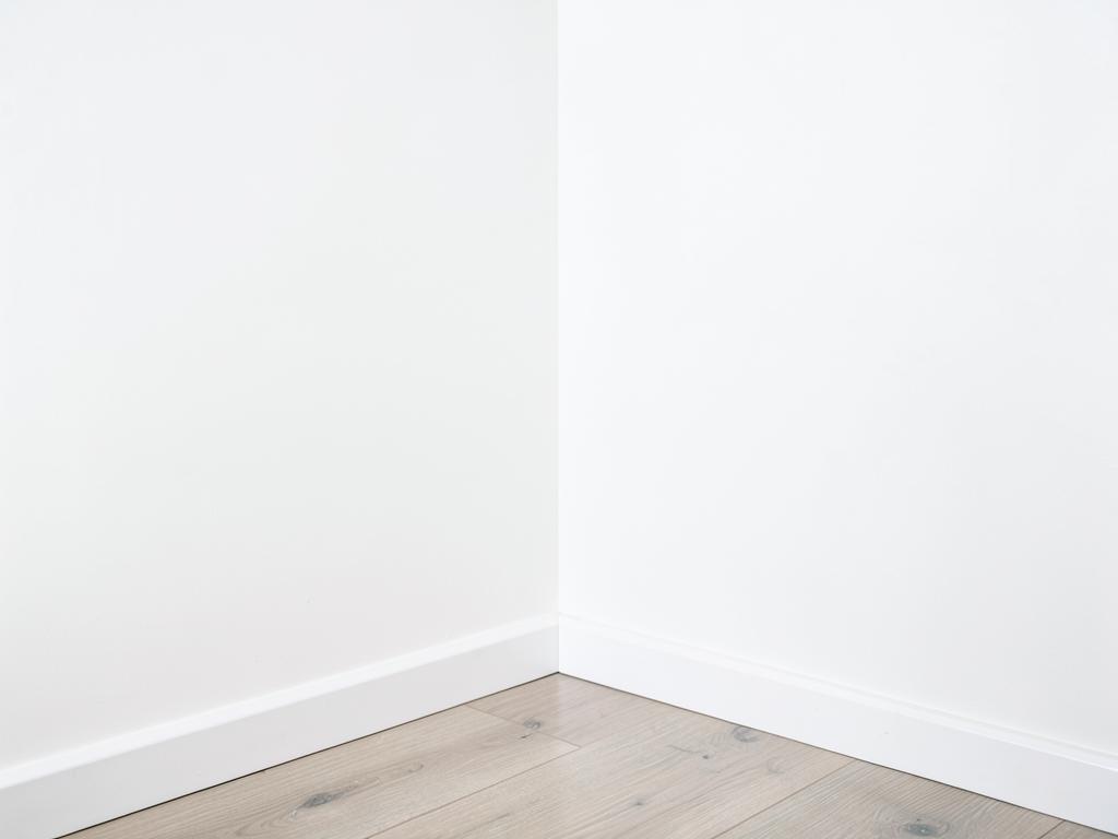 Same bedroom closet corner restored with clean walls and new baseboards